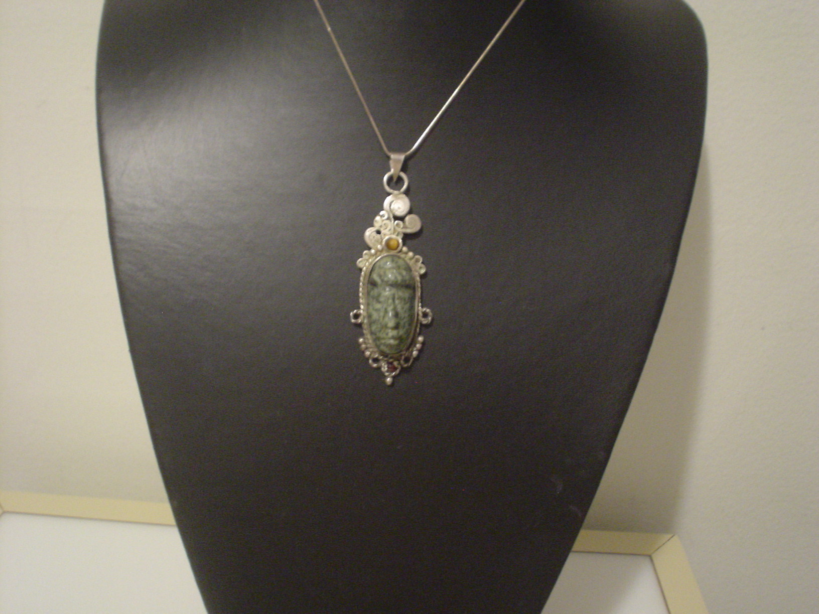 carved green pendant